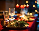 Elegant Christmas table setting adorned with festive decor and candlelight ambiance.